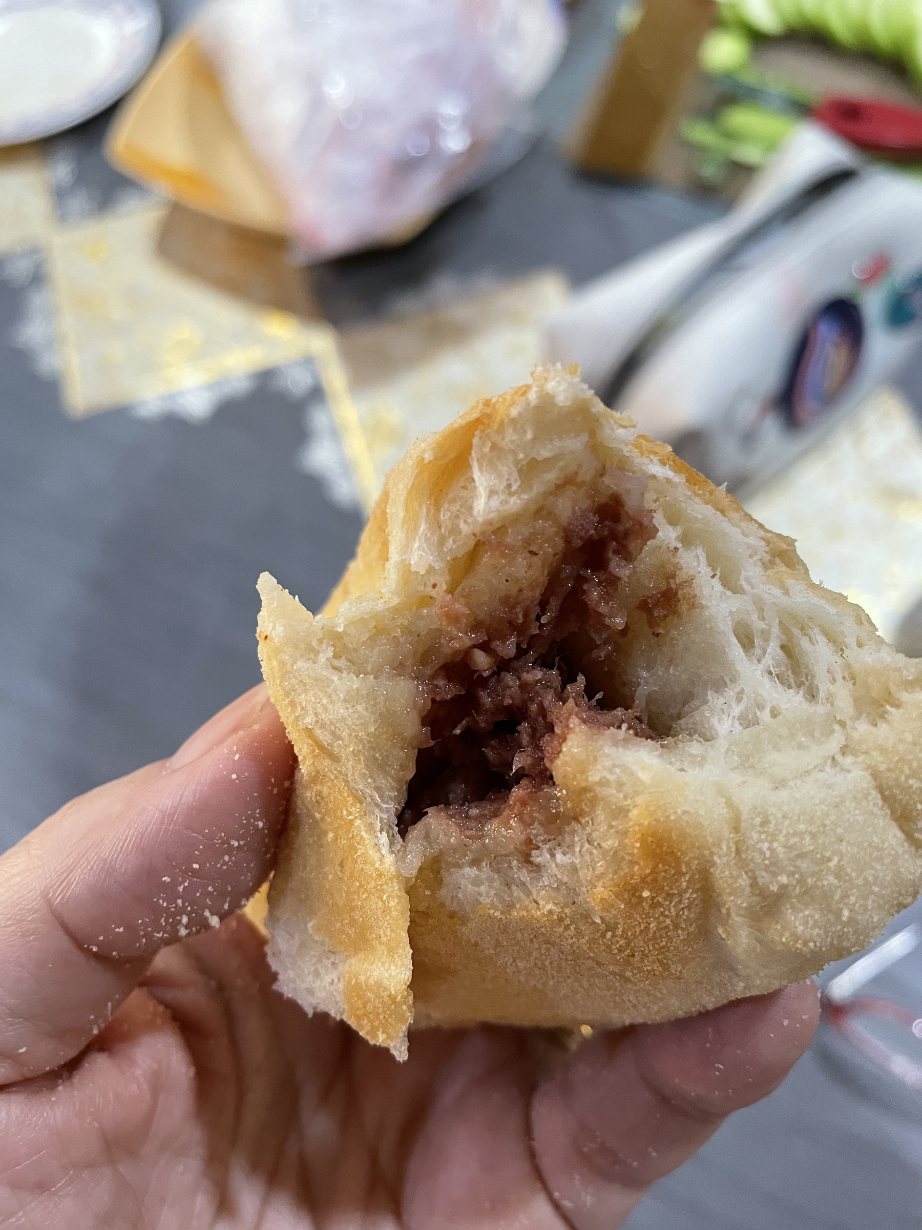 cross-section of pandesal showing the corned beef filling