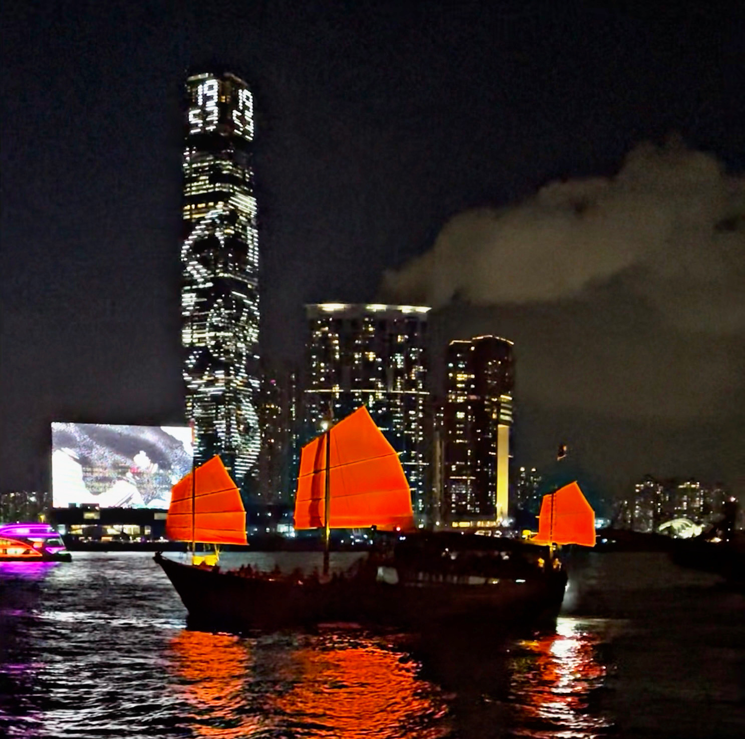 A red junk carrying tourists ply Victoria Harbour in Hong Kong 
