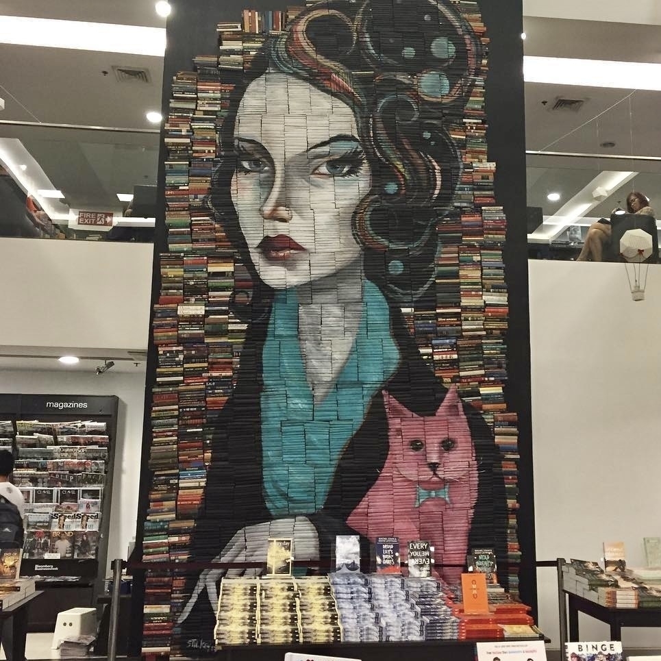 A mosaic of books depicting a lady and a cat