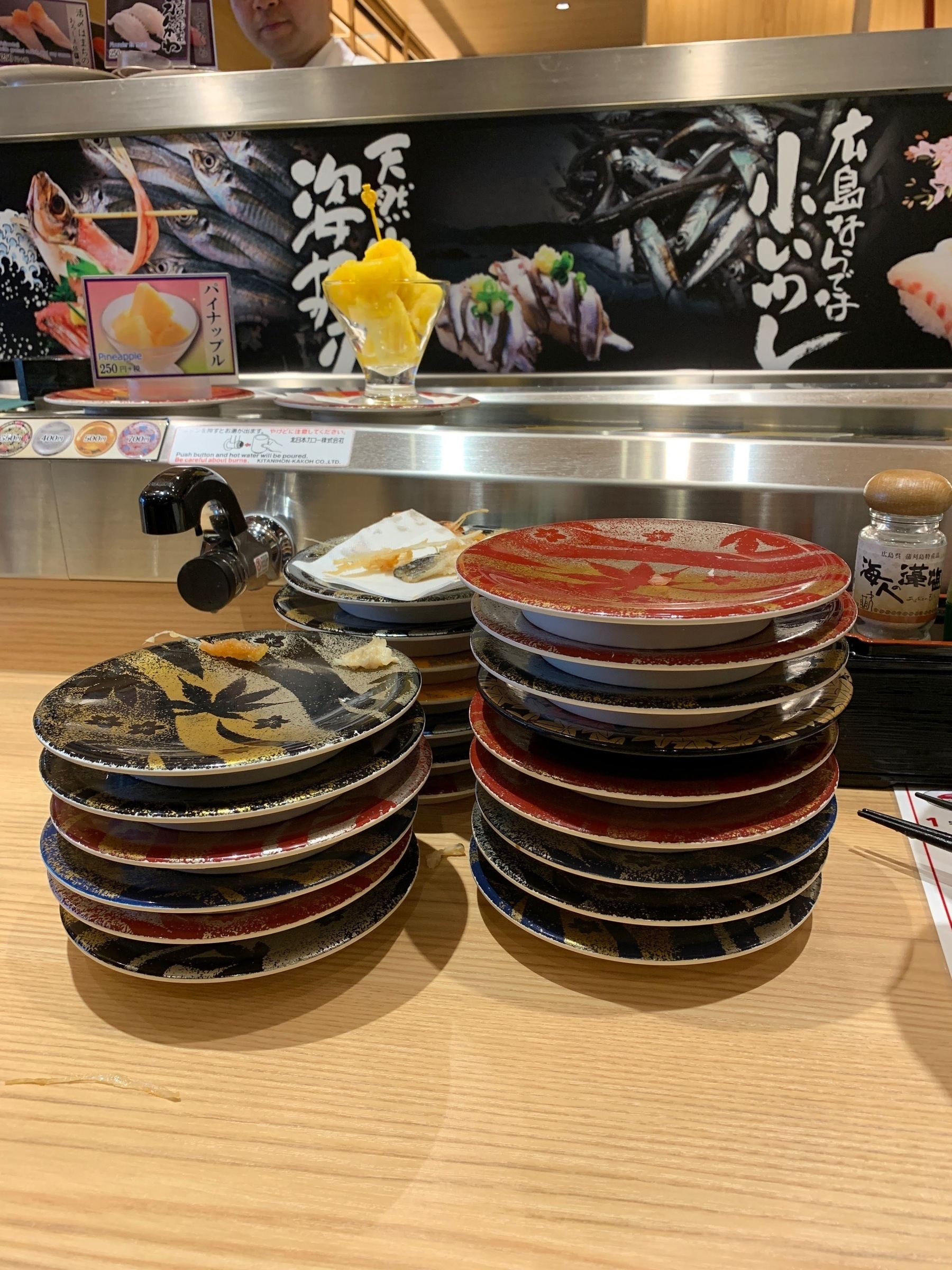 Empty plates stacked on one another in a sushi restaurant