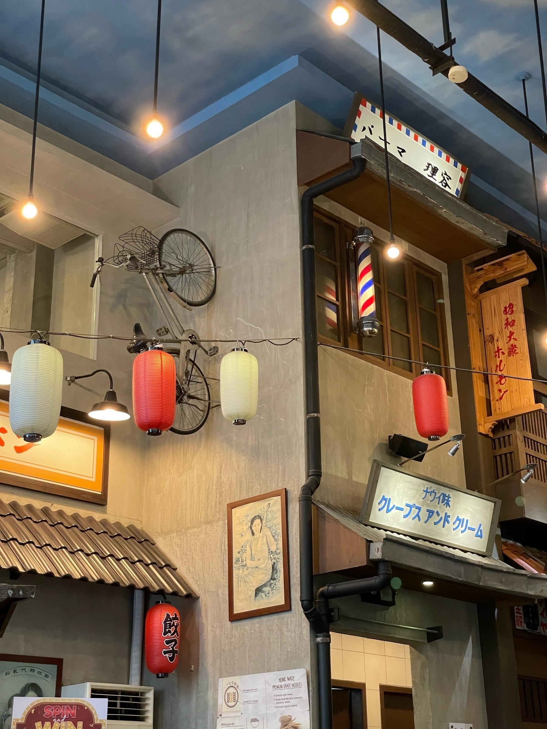 Interior of a Japanese restaurant with a bicycle aesthetically glued to the wall