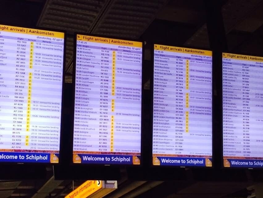 flight schedules are displayed on an electronic board in Schiphol Airport in Amsterdam