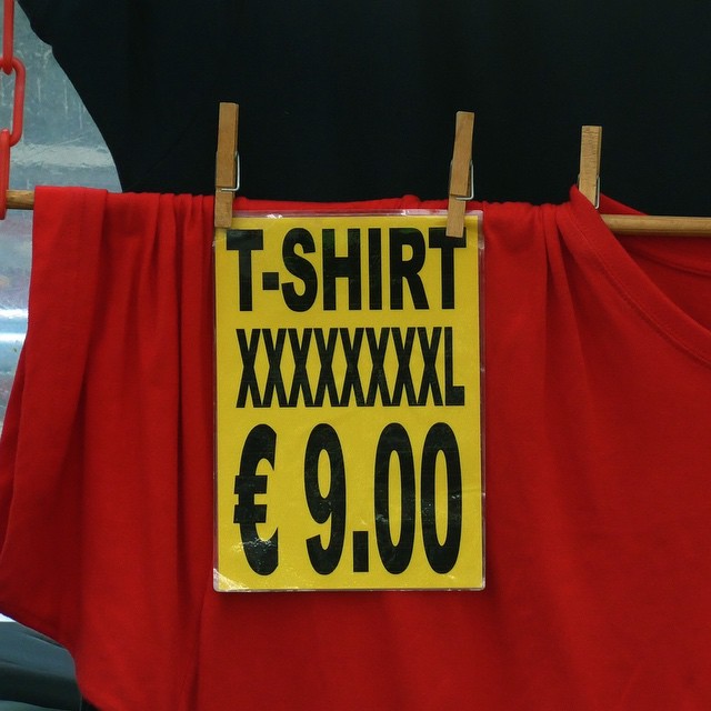 An oversized t-shirt advertised to be 8XL and being sold for €9.00 in the market