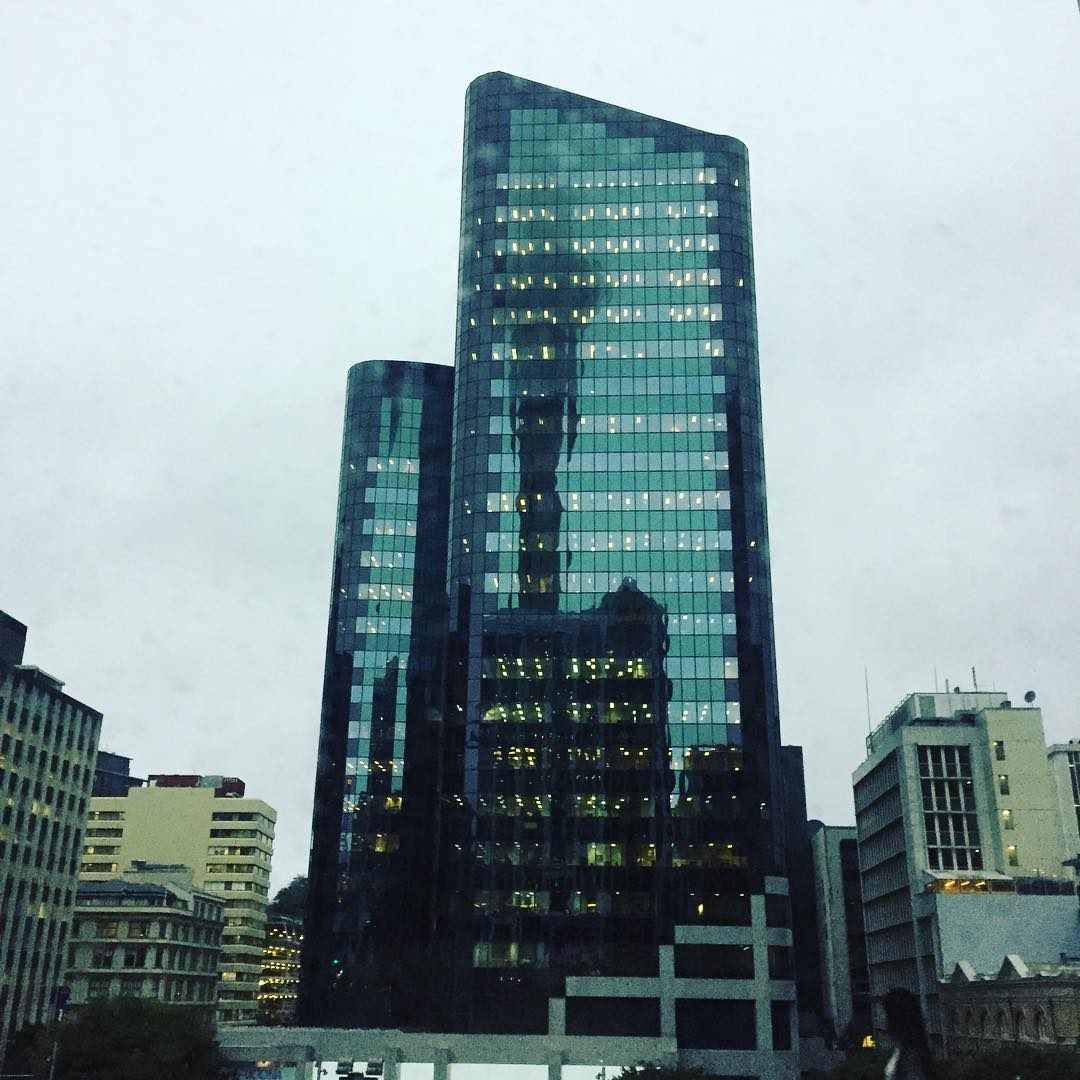 Auckland's Sky Tower is mirrored in one of the city's skyscrapers.