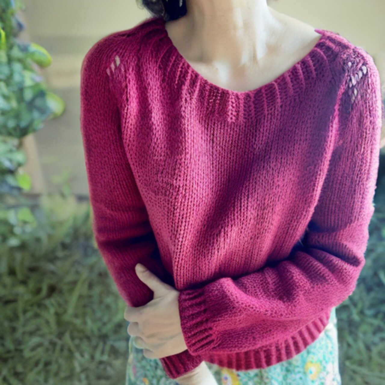 a handknit sweater in dark magenta modeled by myself
