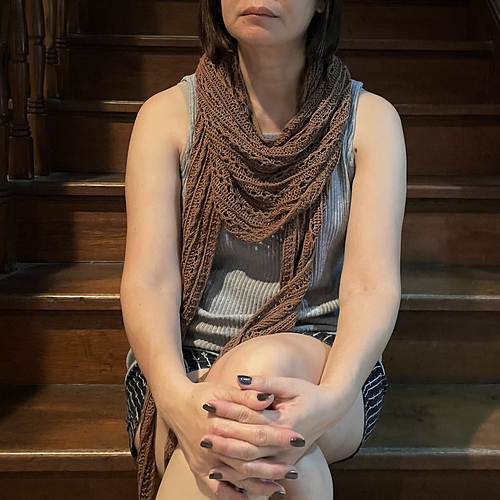 I'm modeling my latest hand-knitted scarf. It is brown, it is 100% silk, it is super long. I am not comfortable wearing such a long scarf and I did my best to drape it around my neck in the most flattering way I know how.